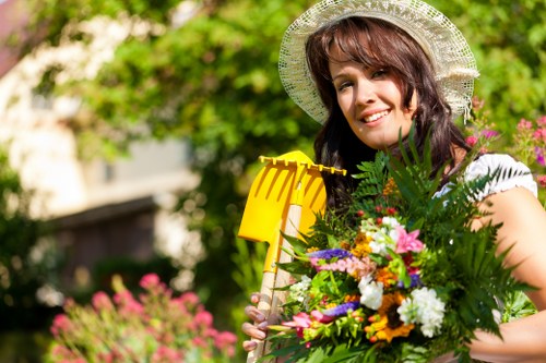 Dalston gardener planting native species in a community garden